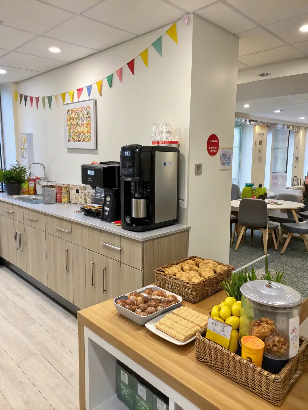 A fully stocked kitchen area with a coffee machine, refrigerator, and snacks, providing refreshments for members at Lie Coworking.